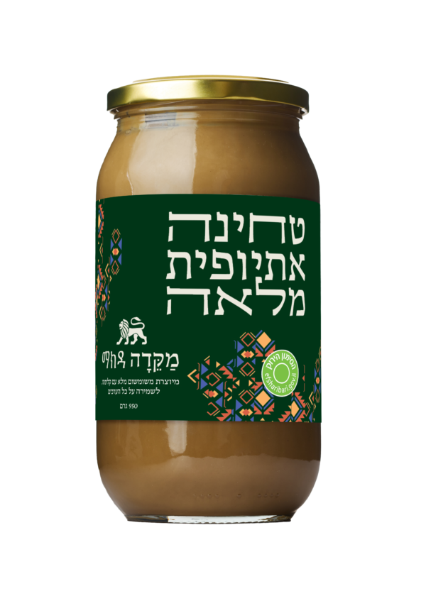 תמונת מוצר של טחינה אתיופית מלאה בתוך צנצנת זכוכית שקופה המציגה טחינה גולמית כהה